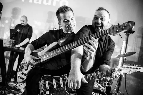 Black-and-white photo of The Gloves bassist and guitarist playing together
