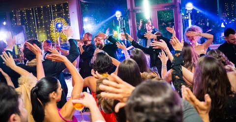 Guests raising their hands during a live performance by The Gloves